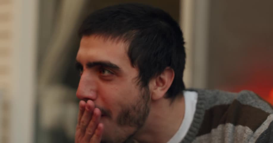 A woman feeds a piece of cheese to a man