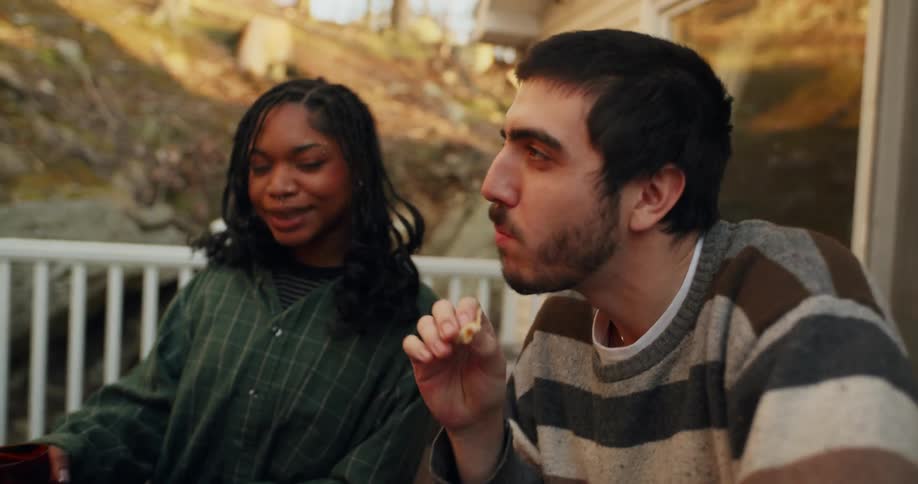 Group of friends sitting at a table eating snacks