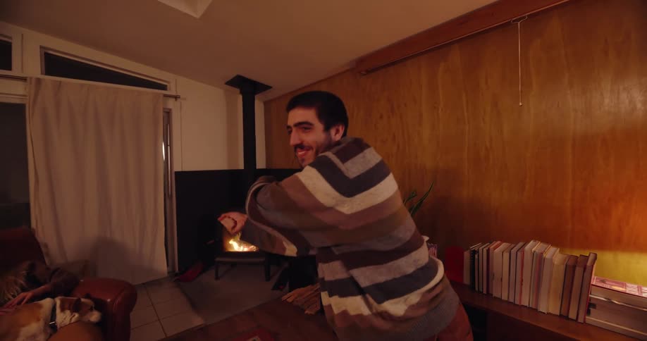 Man playing charades with friends in a living room