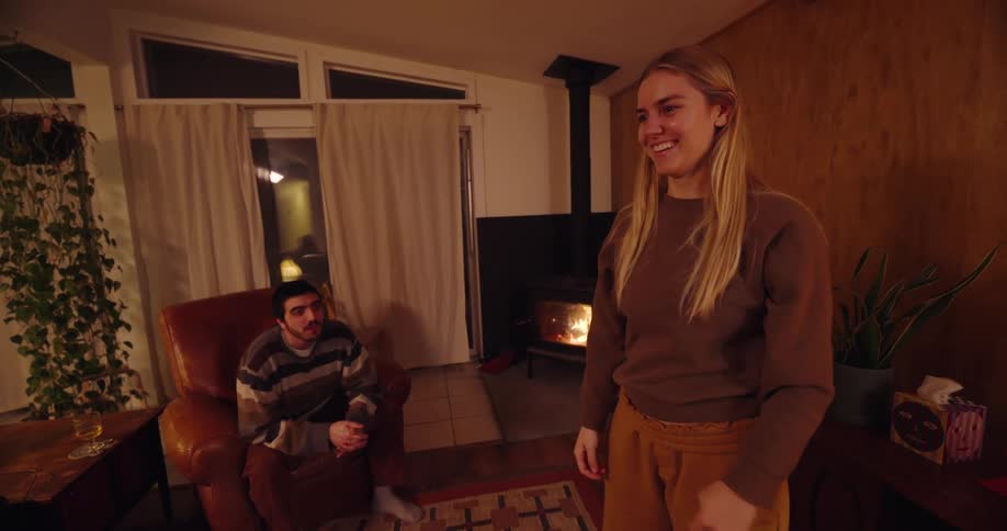 Group of people playing games and having fun in a living room at night