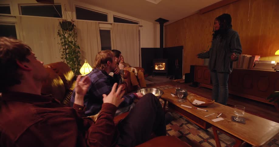 Group of friends in a living room having fun playing games