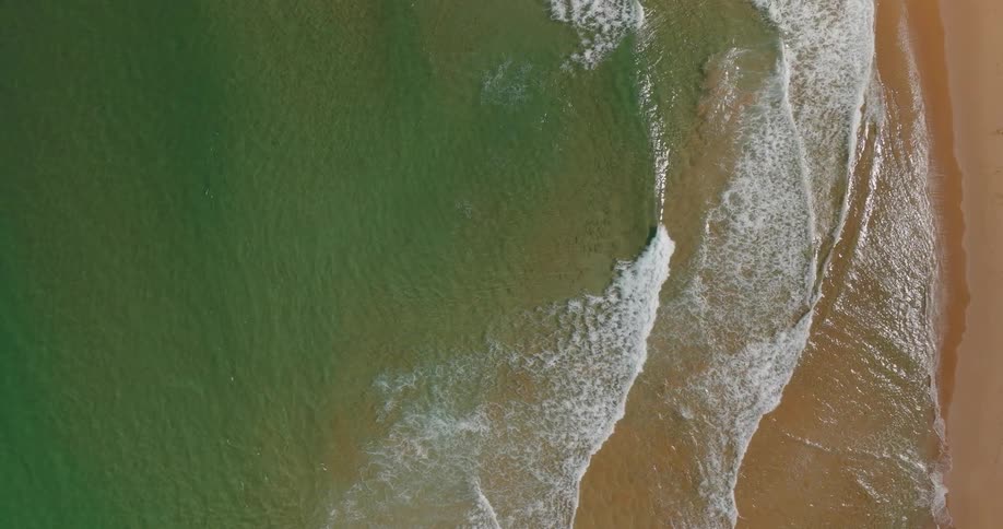 The small waves wash over the beach