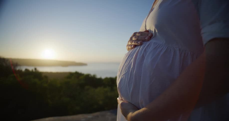 Pregnant woman rubbing belly