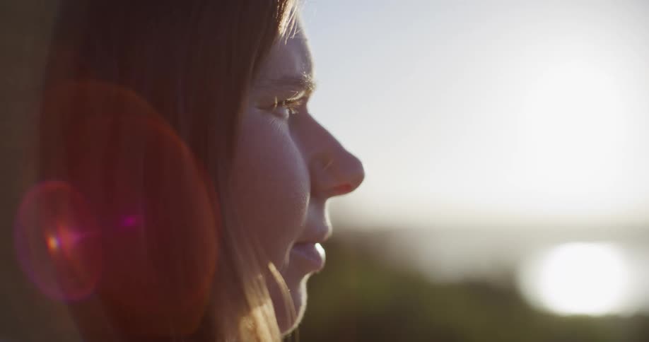 The sun is shining on the womans face