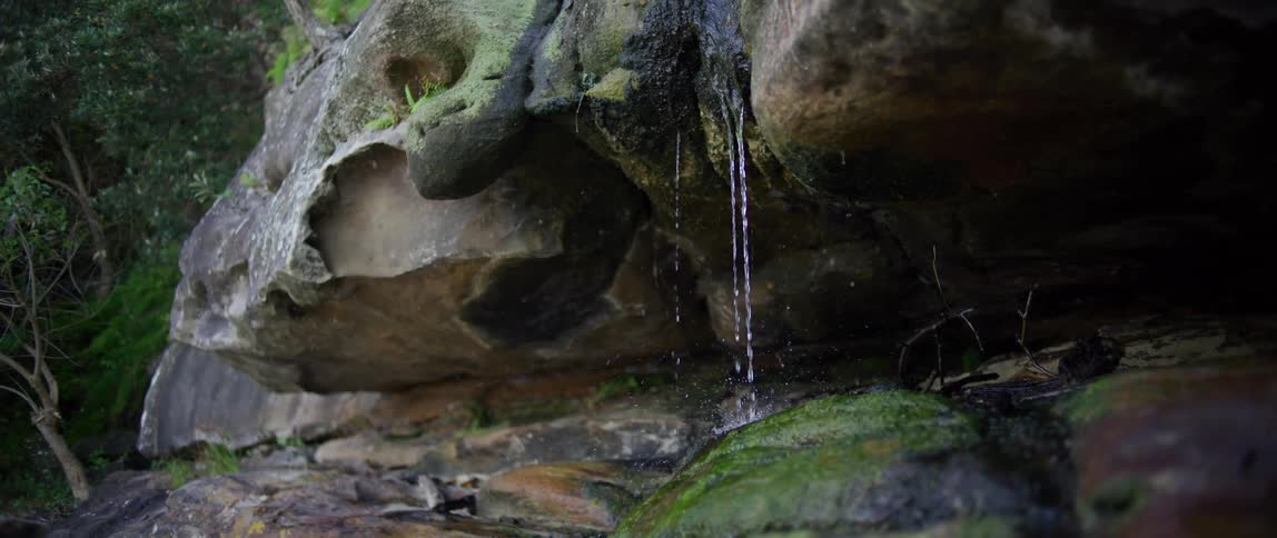 Water running down a rock in nature