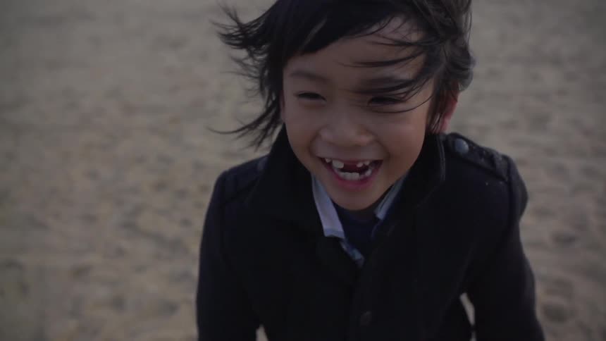 Child runs on the beach