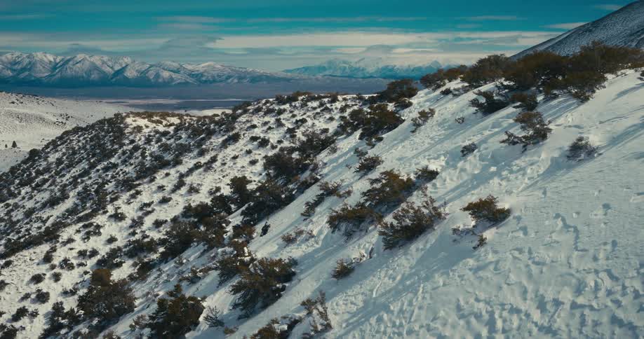 People climbing a snow covered mountain wall
