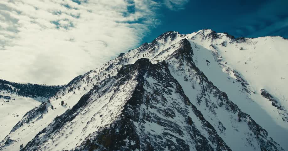 Aerial of mountain top in daytime during winter