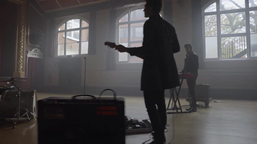 Musical group rehearsing inside a hall