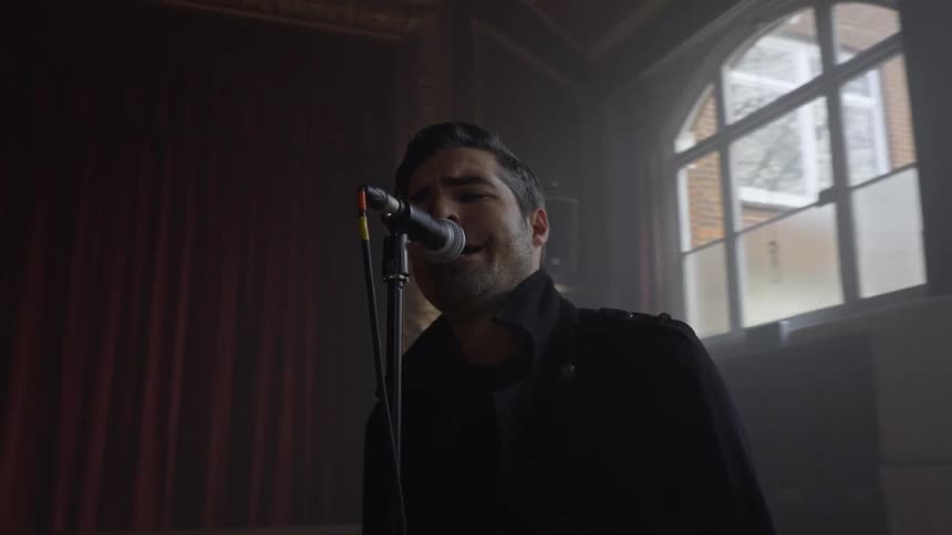 Male vocalist singing in a band at a rehearsal