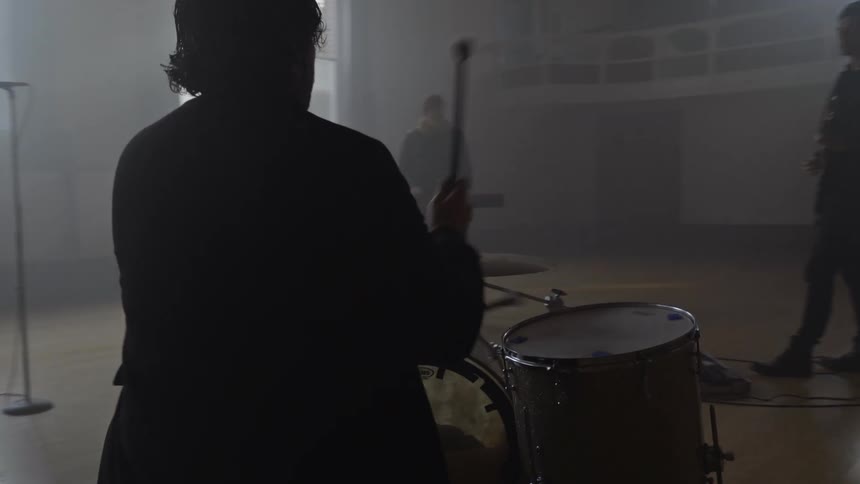 Musical group composed of four people performing indoors