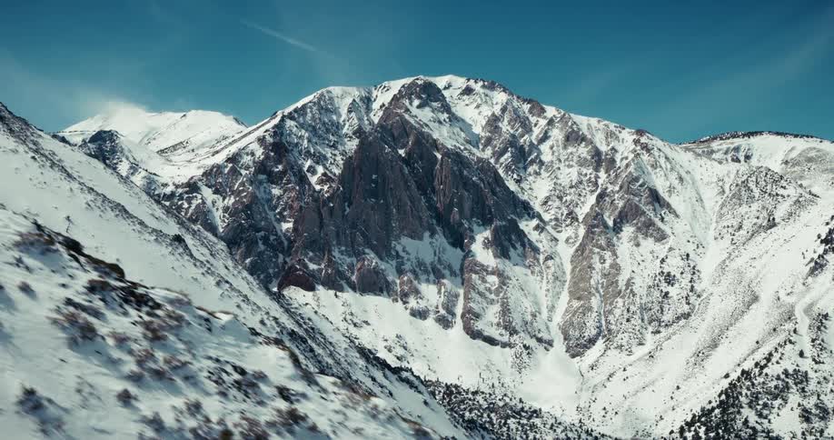 Snow is covering the mountains and valleys of a mountain range