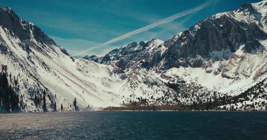 Landscape of a lake surrounded by snowcapped mountains
