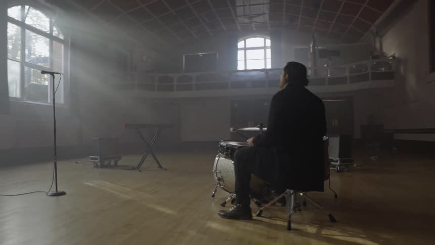 Musicians are in a large room playing music together