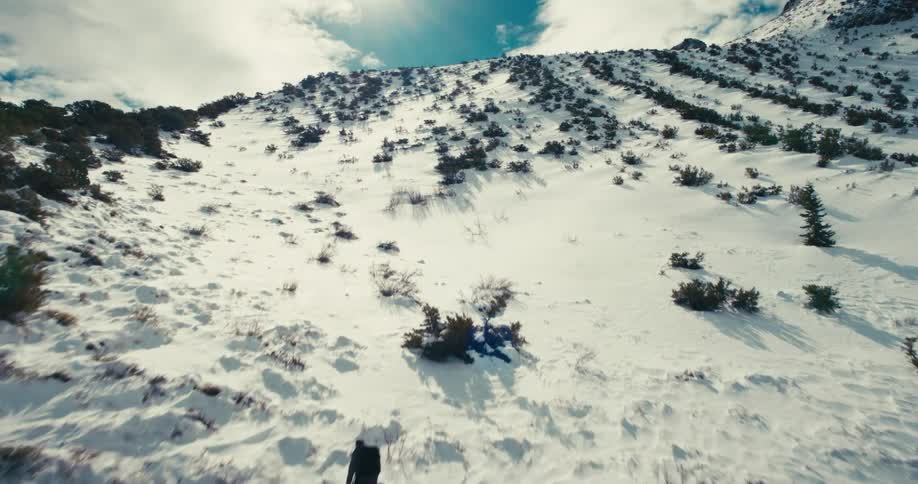 Three people climbing a snowy mountain