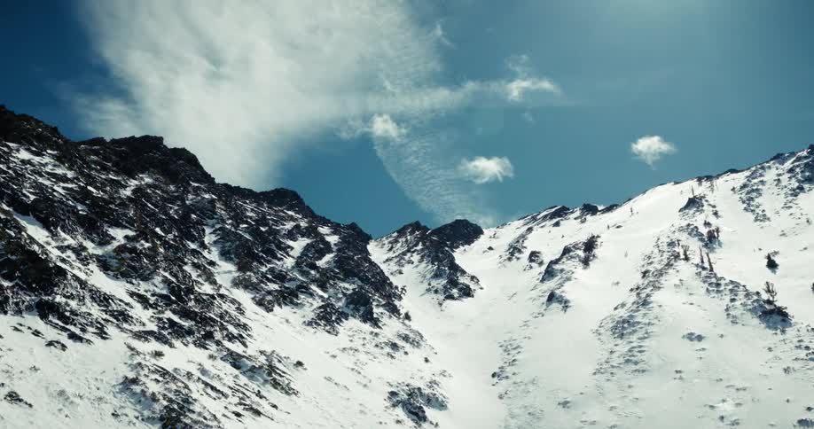 Aerial landscape of a blue sky over snowy mountains