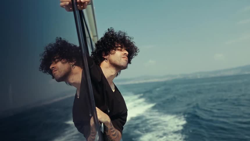 A man leans out the window of a boat