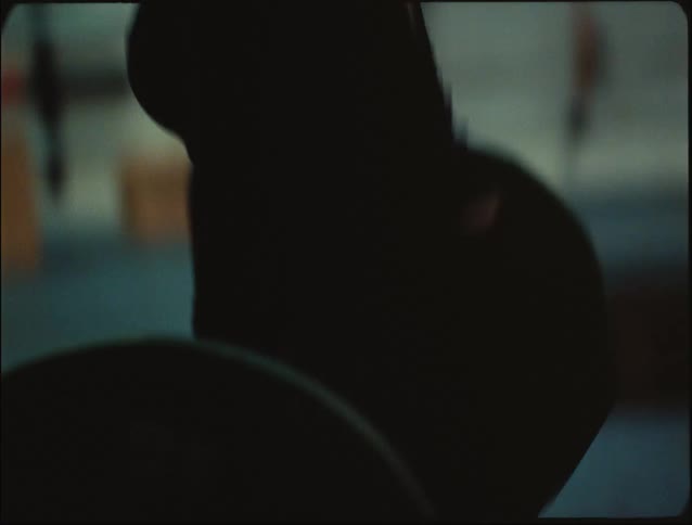 A woman at the gym lifting weights