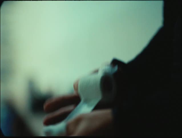 Blonde woman bandaging her thumb