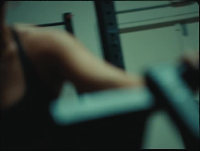 People including a blonde woman doing intense exercise on an elliptical