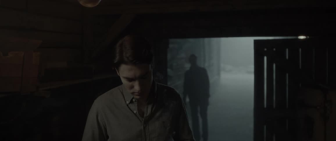 A man smokes a cigarette while another paces outside