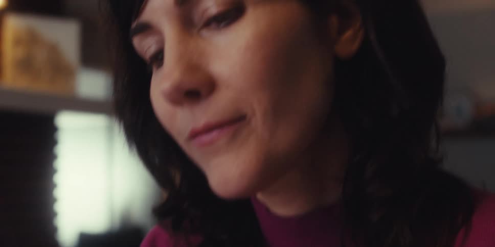 A woman is writing on her tablet with a stylus