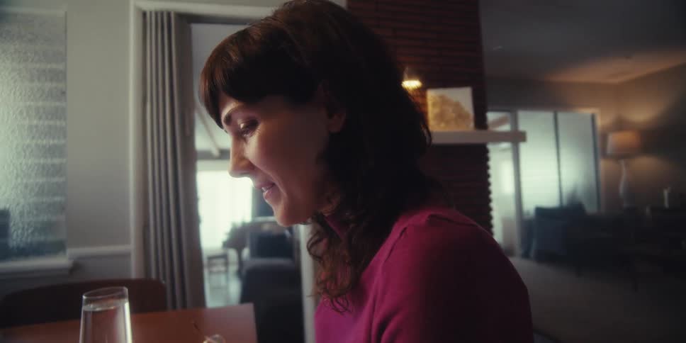 A woman is using a stylus on her tablet