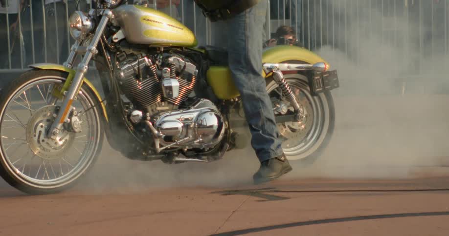 A man riding a gold motorcycle