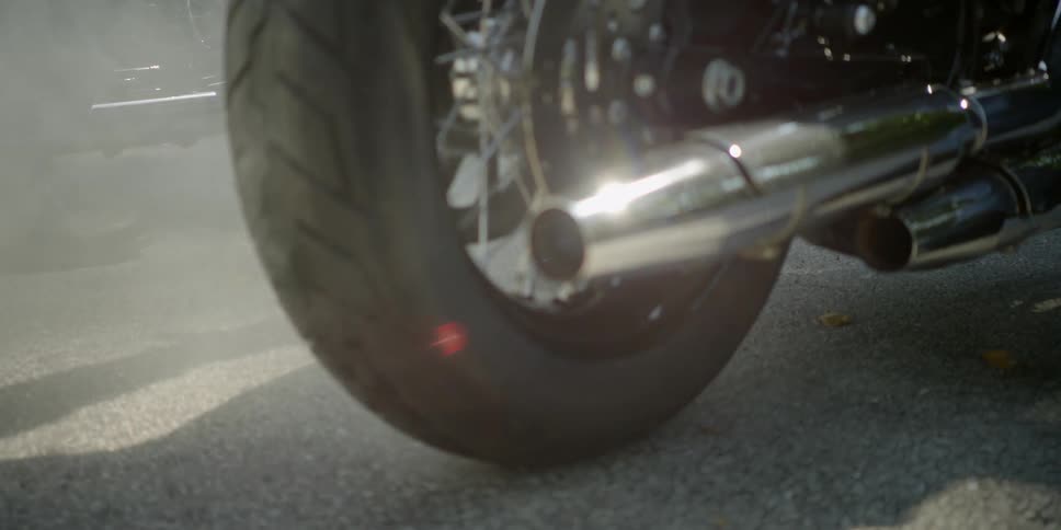 The exhaust pipe of a motorcycle on the road