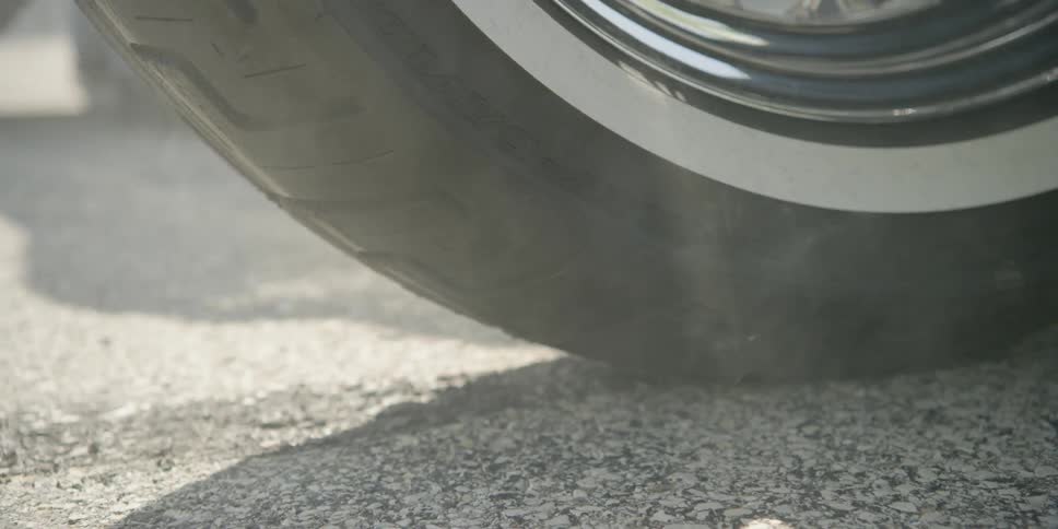 Smoke pours from a rubber tire
