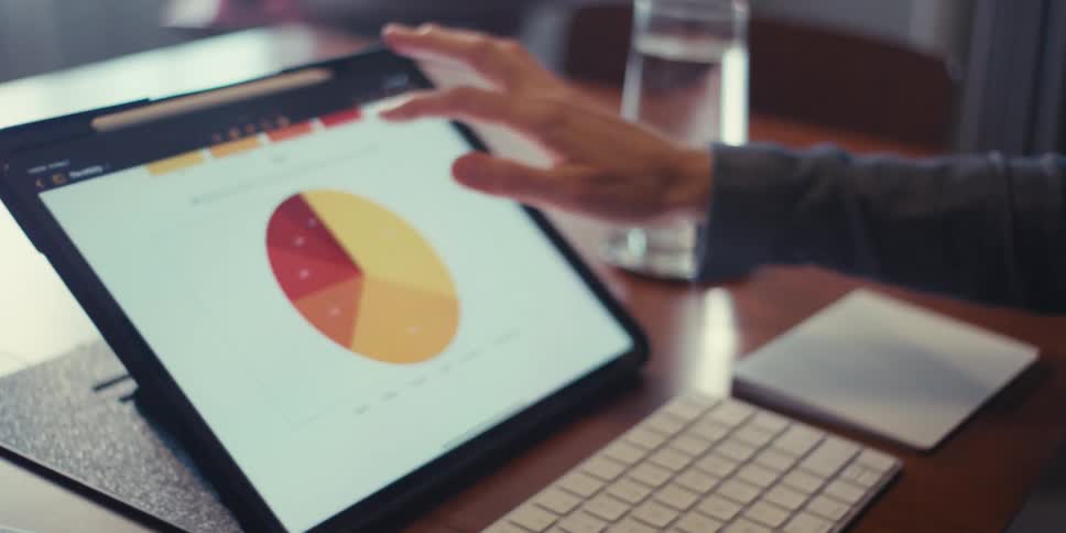 Woman with glasses interacting with a tablet
