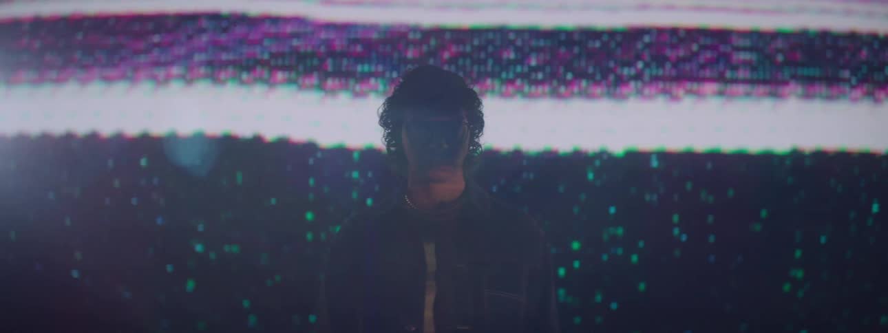 Man stands in front of a large television that loses its signal