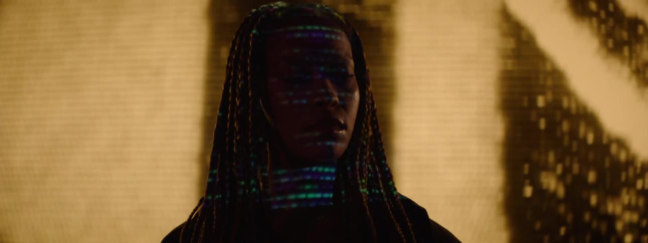 A woman checks her cell phone as the projector flashes on her face