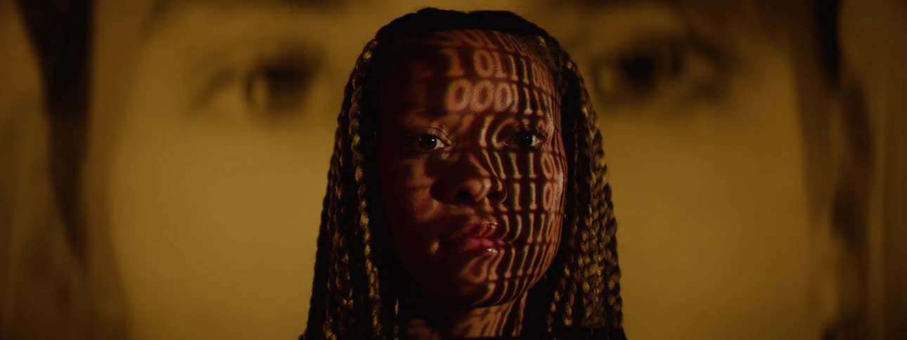 A woman has a projection of numbers flashing on her face