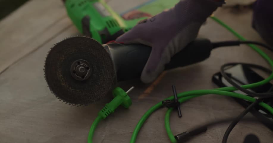 A person picks up the power tool