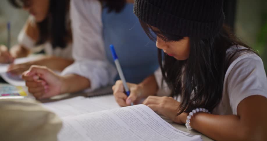 A mother is helping her daughter with homework