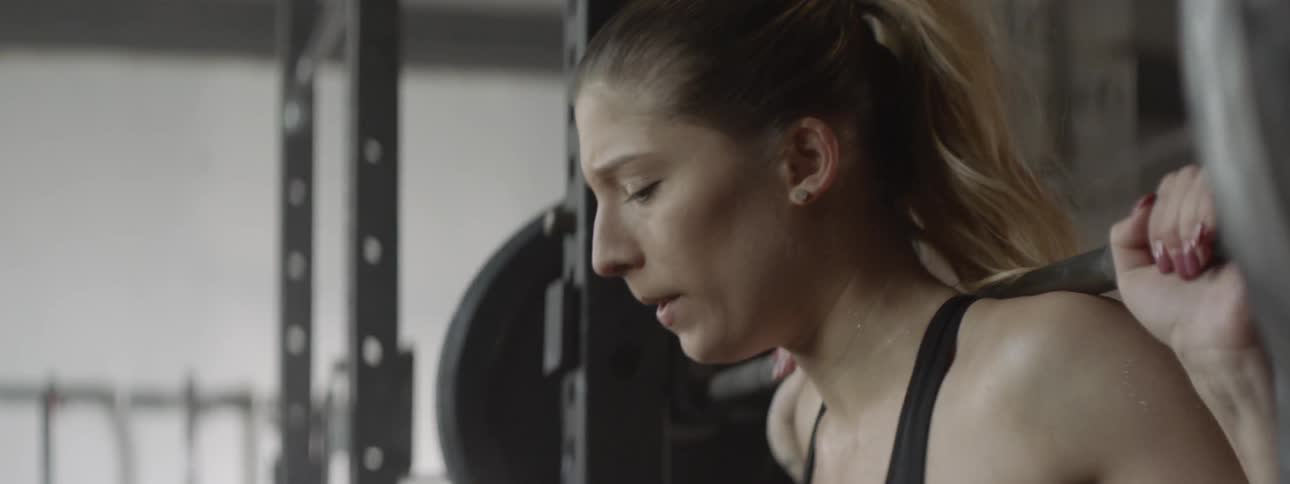 A woman prepares to lift some weights