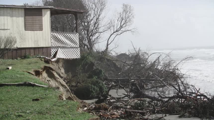 A house near the coast with the ocean in the background