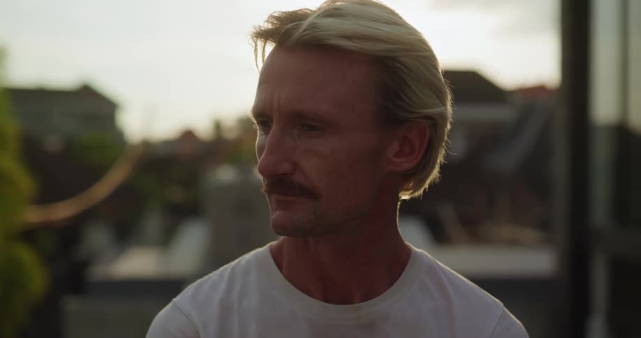 Blond man with mustache outdoors