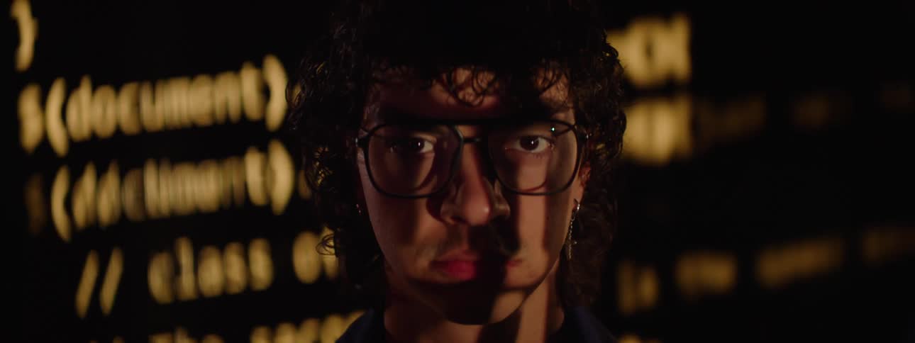 Portrait of a man with glasses and a play of lights on his face
