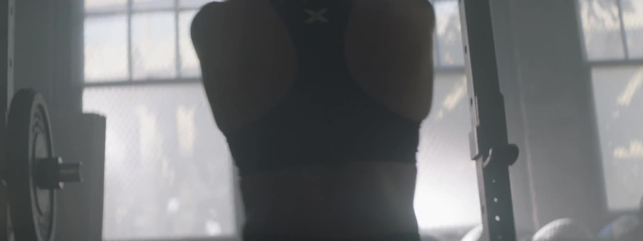 A woman exercises in a gym