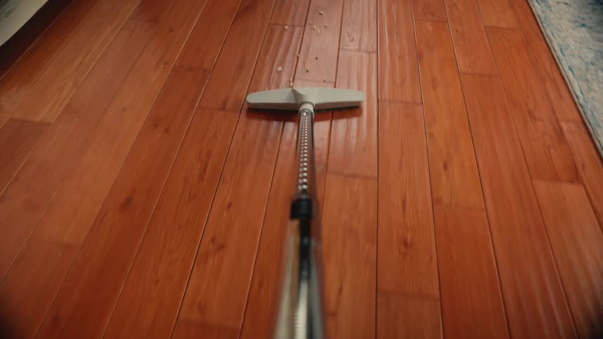 Vacuum cleaner vacuuming a wood floor