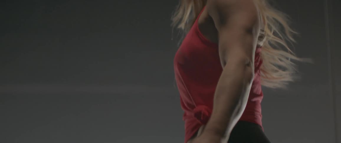 A woman jumps rope in a gym