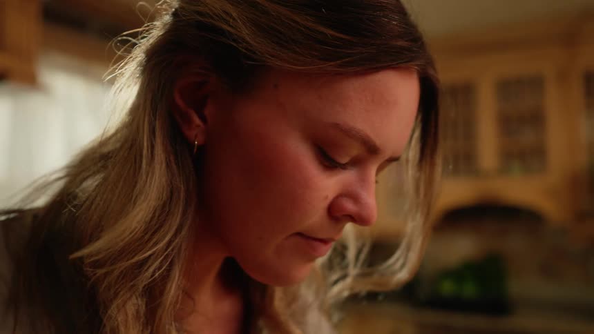 A woman in a living room lost in thought