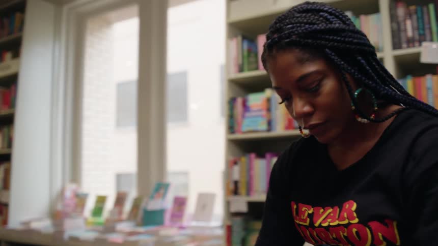 Woman organizing books in a bookstore