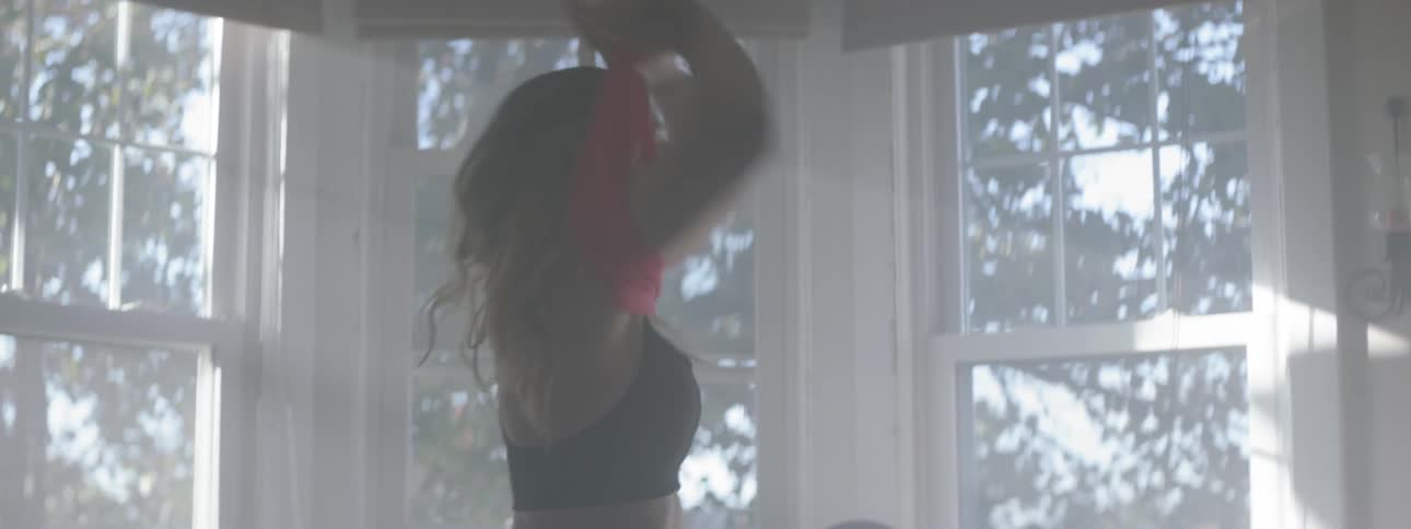 Woman in workout gear packs her gym bag