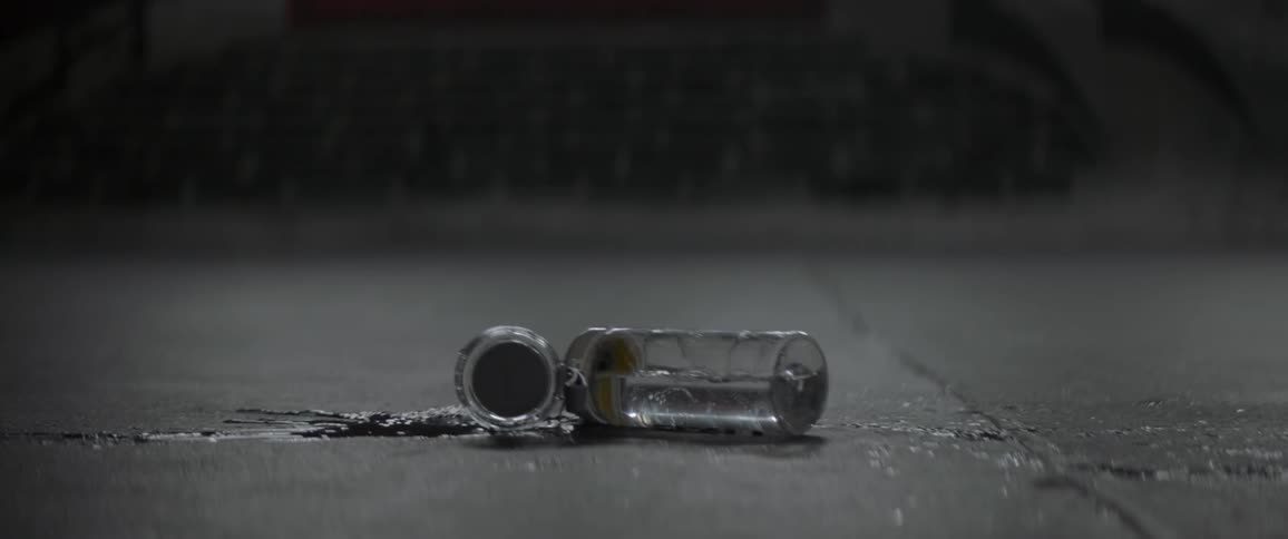A bottle of water being dropped on the ground
