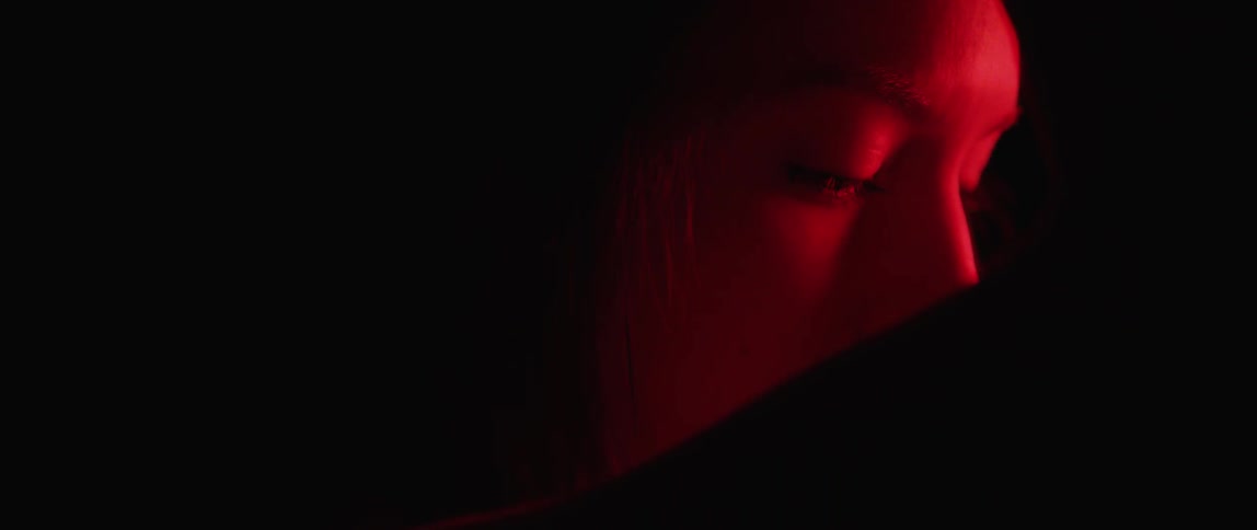Red light shines on a woman's face
