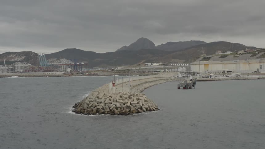 Several industrial buildings and tools are set near the water