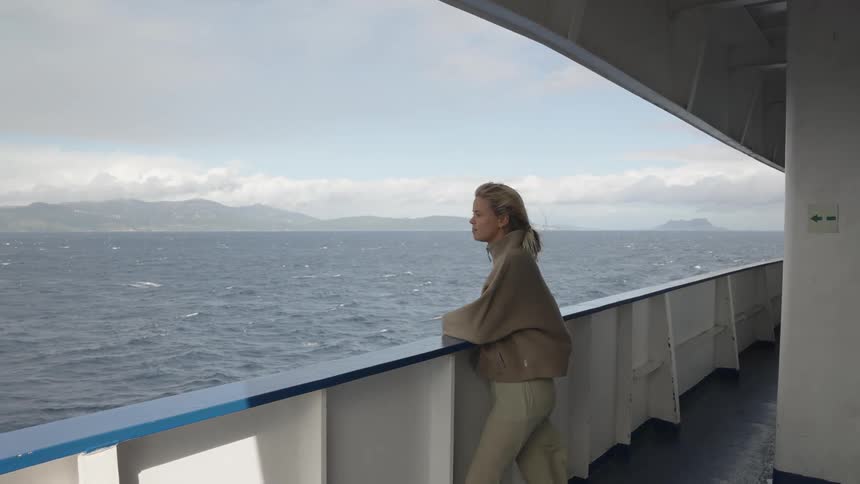 Blonde woman on a boat moving through the sea